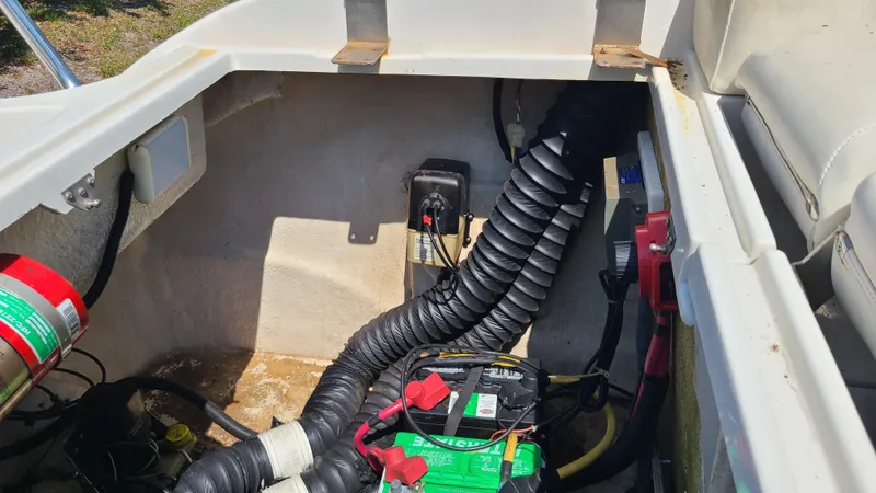 Slide: The Image of 2004 Monterey 268 SS Open Bow Sport boat engine compartment with battery and wiring. - 24