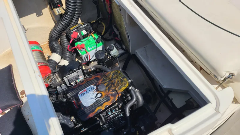 Slide: The Image of 2004 Monterey 268 SS Open Bow Sport boat engine compartment with battery and fire extinguisher. - 26