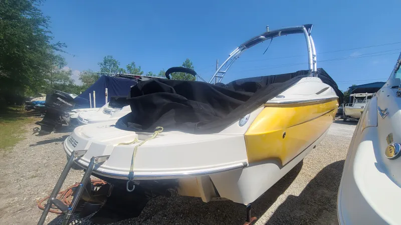 Slide: The Image of 2004 Monterey 268 SS Open Bow Sport boat with yellow and white exterior, covered and parked. - 5
