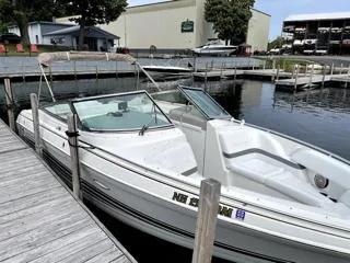 Slide: The Image of 2001 Formula 280 Bow Rider boat docked at a marina, featuring sleek white design. - 0