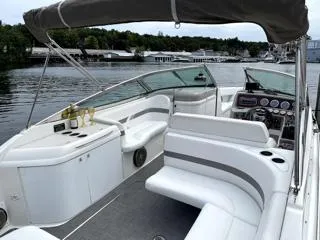 Slide: The Image of 2001 Formula 280 Bow Rider boat with white seating, docked on a calm lake. - 10