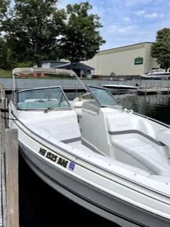 Slide: The Image of 2001 Formula 280 Bow Rider boat docked at a marina, featuring sleek white design. - 2