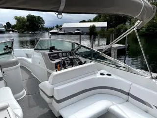 Slide: The Image of 2001 Formula 280 Bow Rider boat with sleek interior, docked by a serene waterfront. - 3