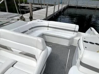 Slide: The Image of 2001 Formula 280 Bow Rider boat interior with white seating near a dock. - 8