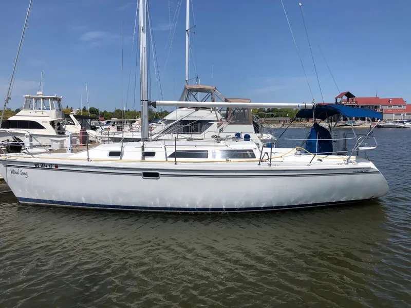 Slide: The Image of 1995 Catalina 320 sailboat docked in a marina on a sunny day. - 0