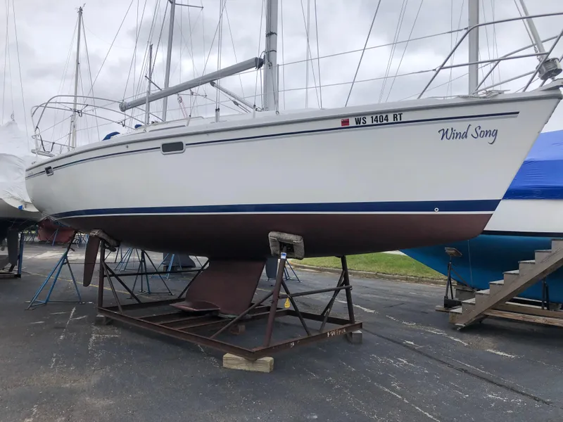Slide: The Image of 1995 Catalina 320 sailboat named Wind Song on a stand in a boatyard. - 10