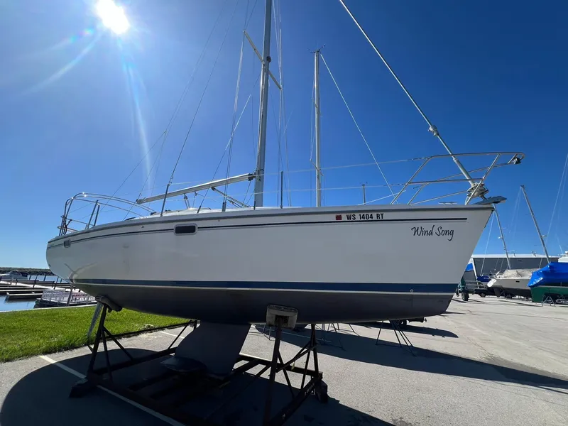 Slide: The Image of 1995 Catalina 320 sailboat Wind Song on a stand in a marina. - 12