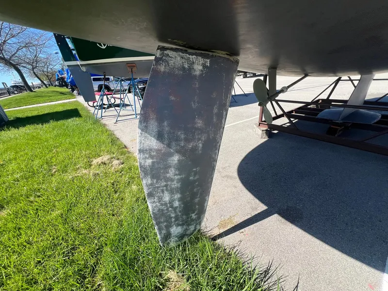 Slide: The Image of Catalina 320 sailboat keel on grass, 1995 model, close-up view. - 17