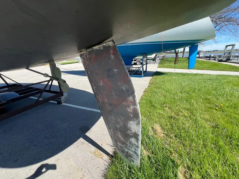 Slide: The Image of Close-up of a 1995 Catalina 320 sailboat rudder on a trailer. - 18