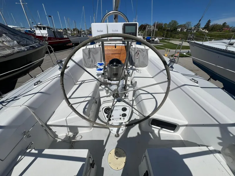 Slide: The Image of Cockpit of a 1995 Catalina 320 sailboat with steering wheel and navigation equipment. - 22