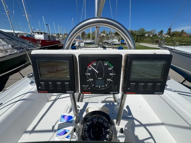 Slide: The Image of Catalina 320 sailboat cockpit with speed, wind, and depth instruments, 1995 model. - 23