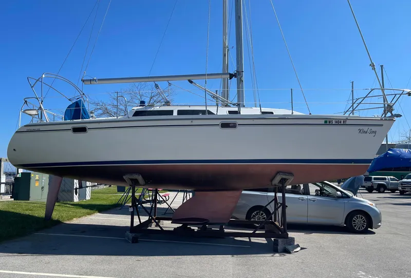 Slide: The Image of 1995 Catalina 320 sailboat on a stand in a boatyard. - 3