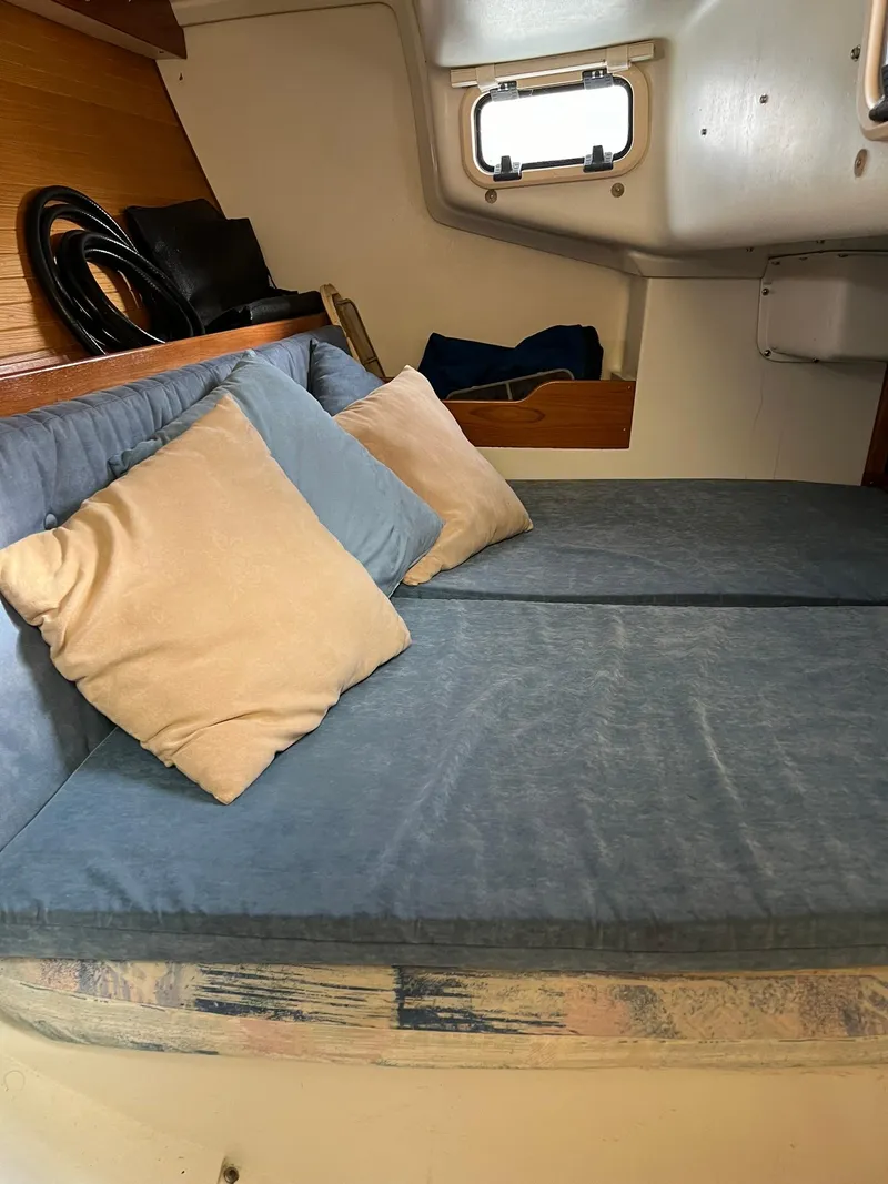 Slide: The Image of Cozy cabin interior of a 1995 Catalina 320 sailboat with blue cushions and pillows. - 37