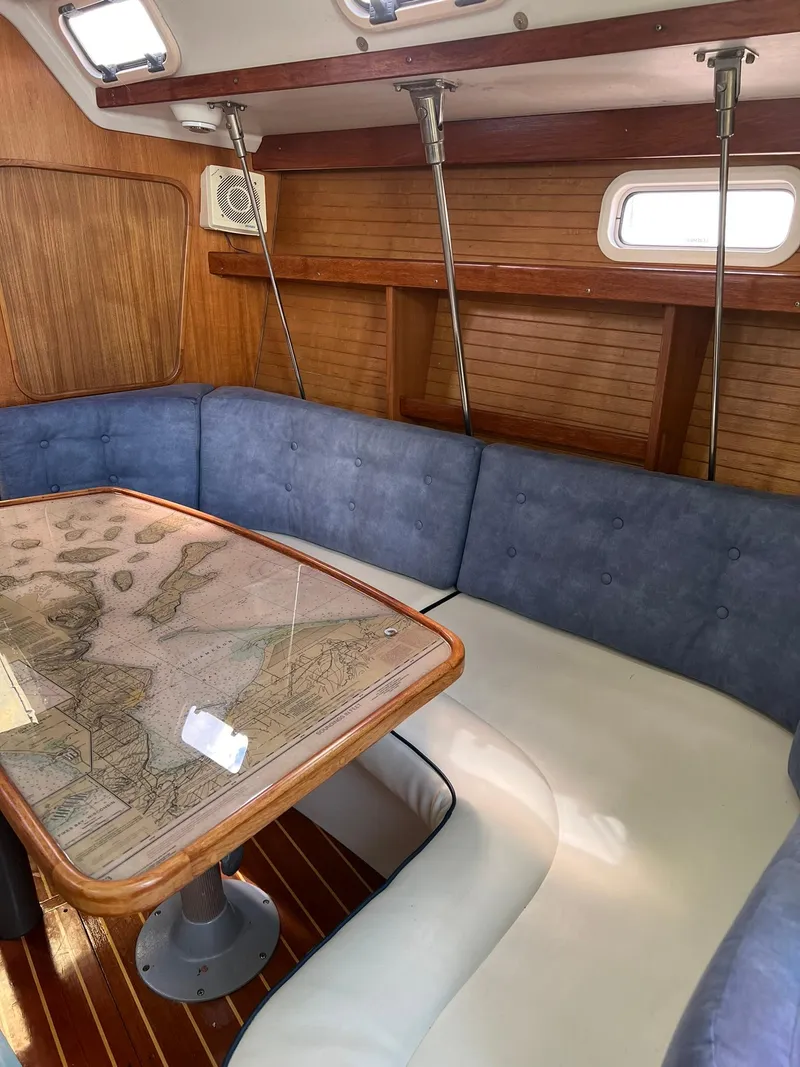 Slide: The Image of Interior of a 1995 Catalina 320 sailboat with a cozy dining area. - 40