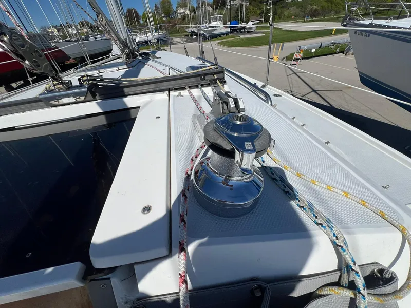 Slide: The Image of 1995 Catalina 320 sailboat deck with winch and ropes. - 49