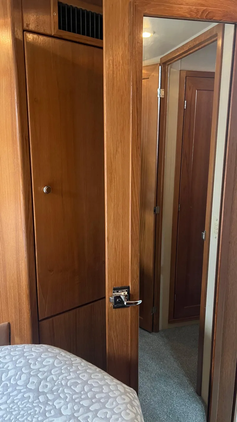 Slide: The Image of Interior of 1999 Bayliner 3988 Motoryacht with wooden doors and cozy cabin. - 18