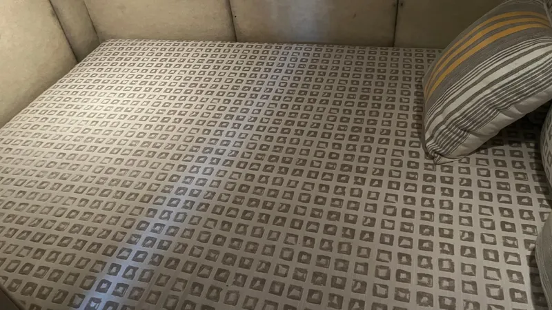 Slide: The Image of 1999 Bayliner 3988 Motoryacht interior bed with patterned bedding and striped pillow. - 19