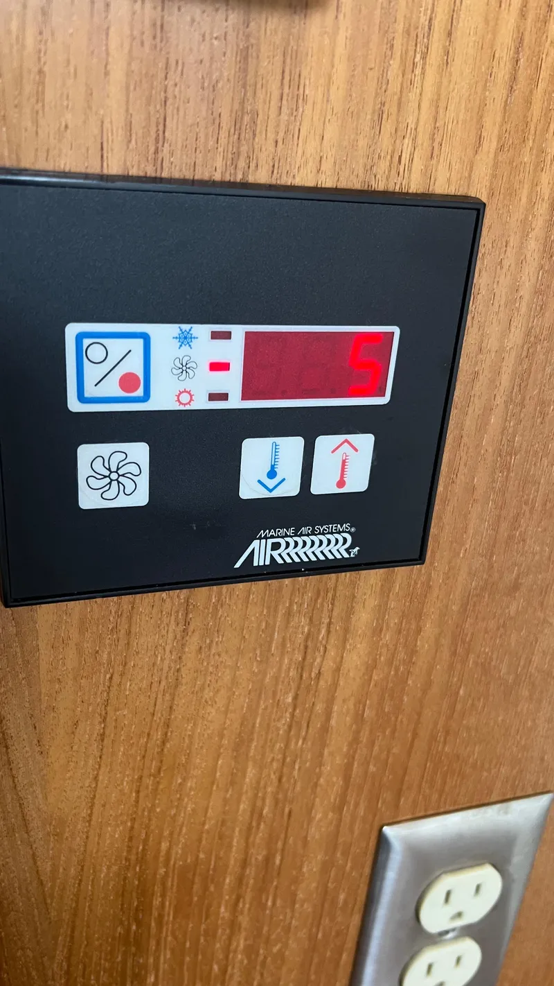 Slide: The Image of Control panel on 1999 Bayliner 3988 Motoryacht, displaying settings and temperature. - 23