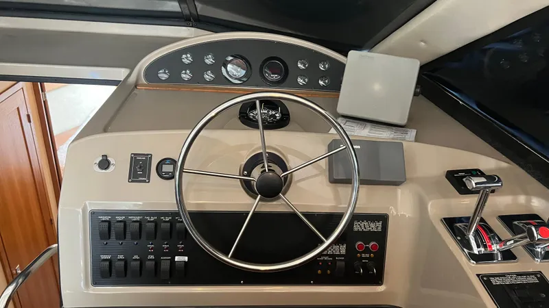 Slide: The Image of 1999 Bayliner 3988 Motoryacht helm with steering wheel and control panel. - 24