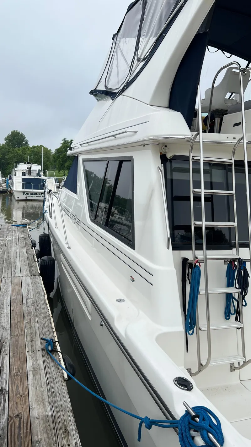 Slide: The Image of 1999 Bayliner 3988 Motoryacht docked, showcasing sleek design and modern features. - 3