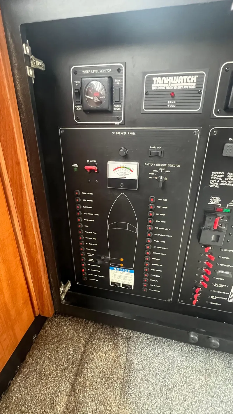 Slide: The Image of Electrical control panel on a 1999 Bayliner 3988 Motoryacht, featuring water level and battery monitors. - 35