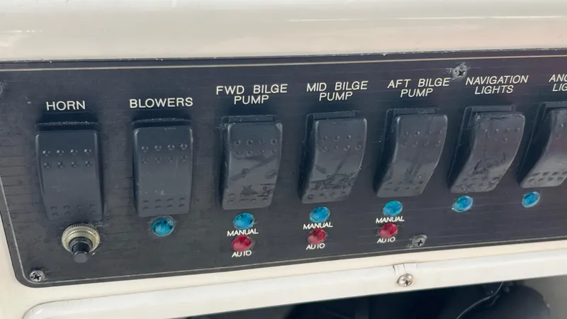 Slide: The Image of Control panel of a 1999 Bayliner 3988 Motoryacht with switches for various functions. - 45