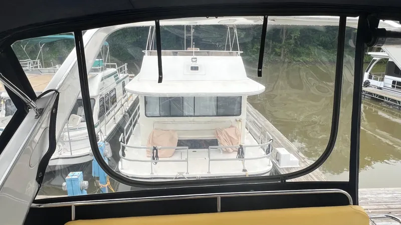 Slide: The Image of 1999 Bayliner 3988 Motoryacht docked at marina, viewed from another boat. - 49