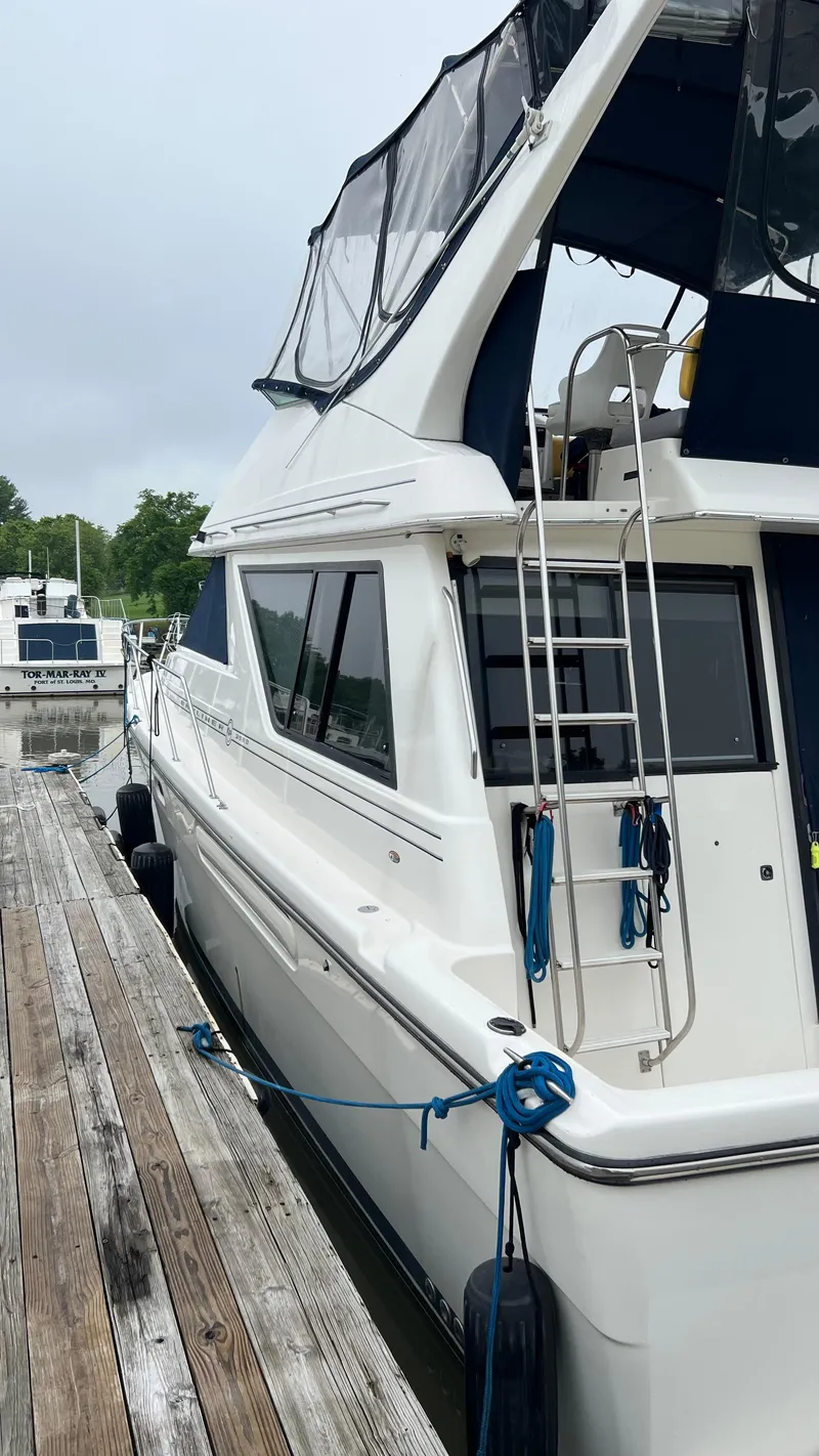 Slide: The Image of 1999 Bayliner 3988 Motoryacht docked, featuring sleek design and modern amenities. - 5