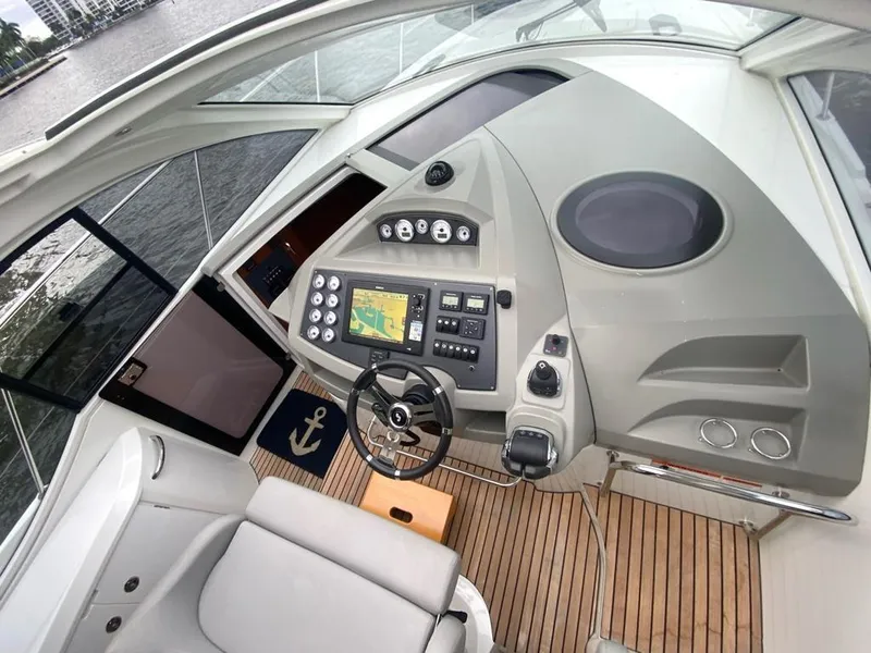 Slide: The Image of Beneteau 38 2014 yacht helm station with navigation system and steering wheel. - 12