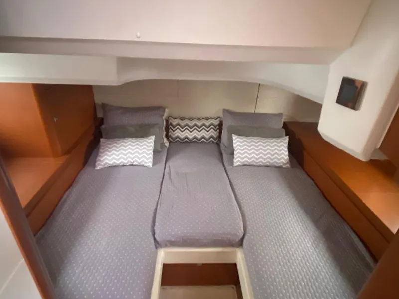 Slide: The Image of Interior cabin of 2014 Beneteau 38 sailboat with twin beds and gray bedding. - 14
