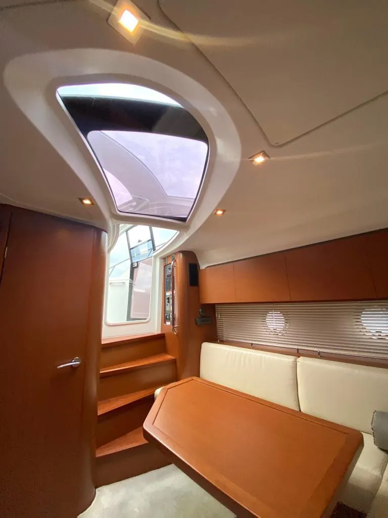 Slide: The Image of Interior of 2014 Beneteau 38 sailboat with skylight and wooden furnishings. - 15