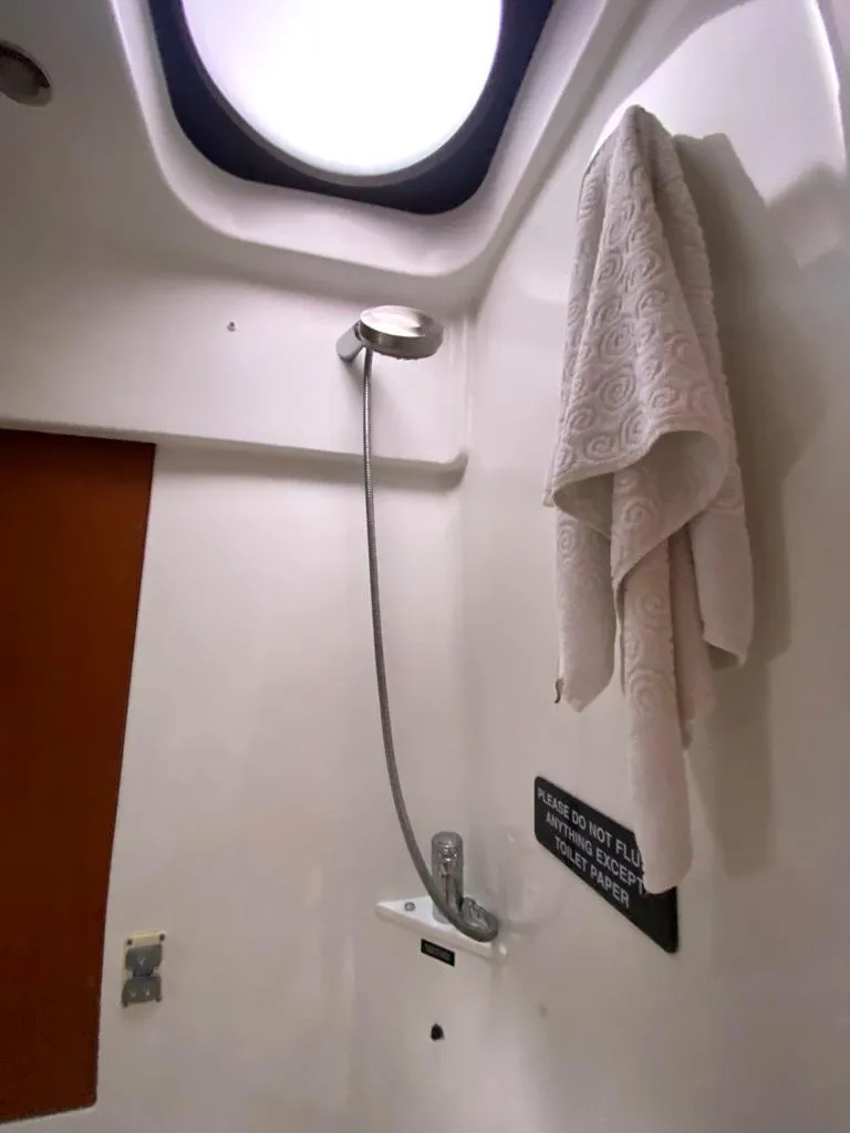 Slide: The Image of 2014 Beneteau 38 shower area with towel and skylight. - 17