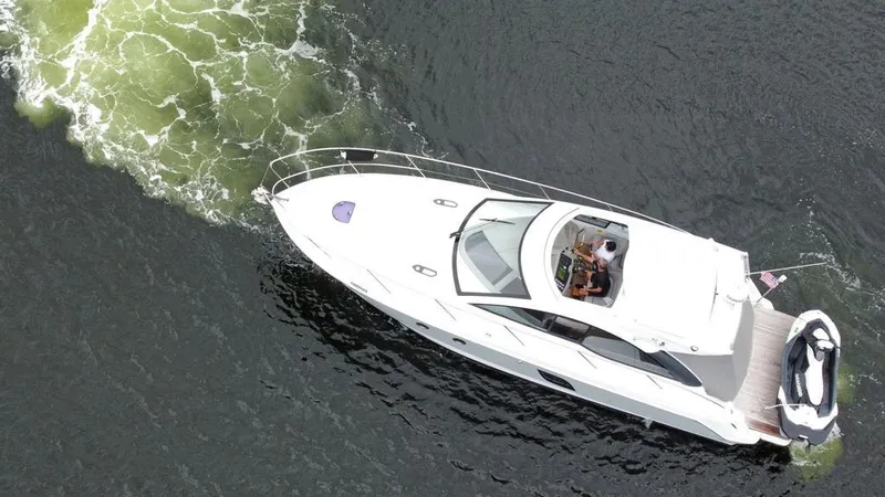 Slide: The Image of Aerial view of a 2014 Beneteau 38 yacht cruising on water. - 2