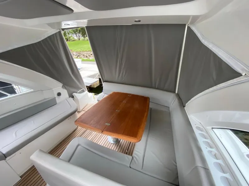 Slide: The Image of Interior seating area of a 2014 Beneteau 38 yacht with a wooden table. - 22
