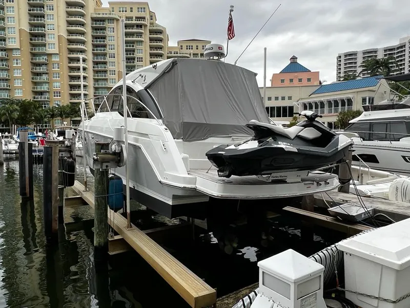 Slide: The Image of 2014 Beneteau 38 yacht docked with jet ski, urban marina background. - 6