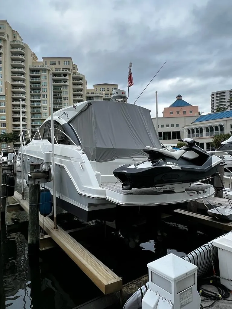 Slide: The Image of 2014 Beneteau 38 yacht docked with jet ski, urban marina background. - 7