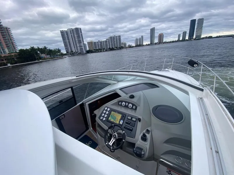 Slide: The Image of 2014 Beneteau 38 yacht helm with city skyline in the background. - 9