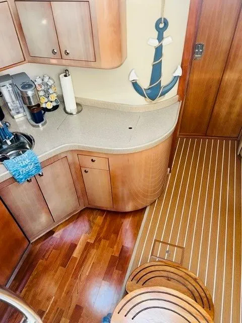 Slide: The Image of 2003 Regal 3860 Commodore yacht interior with wooden cabinets and nautical decor. - 13