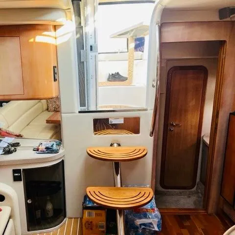 Slide: The Image of Interior of 2003 Regal 3860 Commodore yacht with wooden accents and seating area. - 14