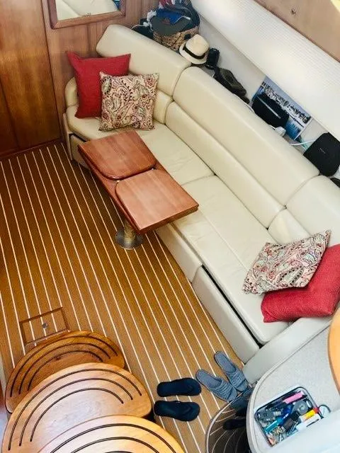 Slide: The Image of Luxurious interior of 2003 Regal 3860 Commodore yacht with cream sofa and wooden flooring. - 15
