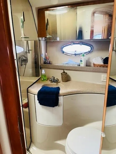 Slide: The Image of 2003 Regal 3860 Commodore yacht bathroom with sink, mirror, and shower. - 16