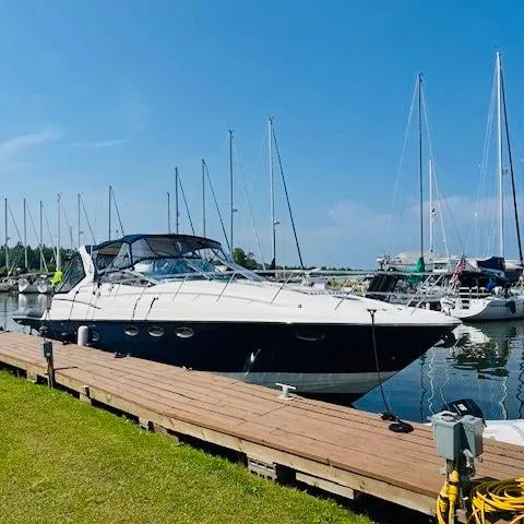 Slide: The Image of 2003 Regal 3860 Commodore yacht docked at marina on a sunny day. - 2