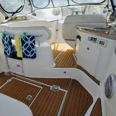 Slide: The Image of 2003 Regal 3860 Commodore yacht interior with wood flooring and modern amenities. - 5