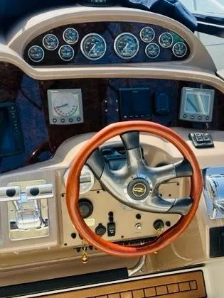 Slide: The Image of 2003 Regal 3860 Commodore dashboard with gauges and wooden steering wheel. - 6