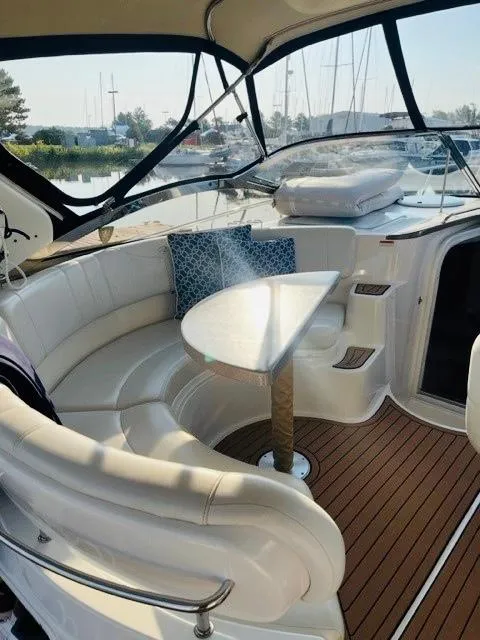 Slide: The Image of 2003 Regal 3860 Commodore yacht interior with curved seating and table. - 8