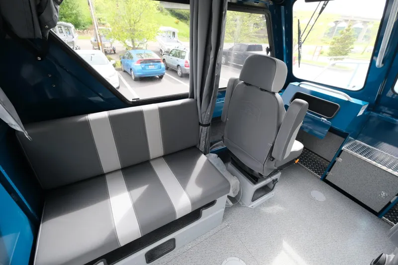 Slide: The Image of Interior of 2024 Hewescraft 220 Ocean Pro boat with seating and windows. - 10