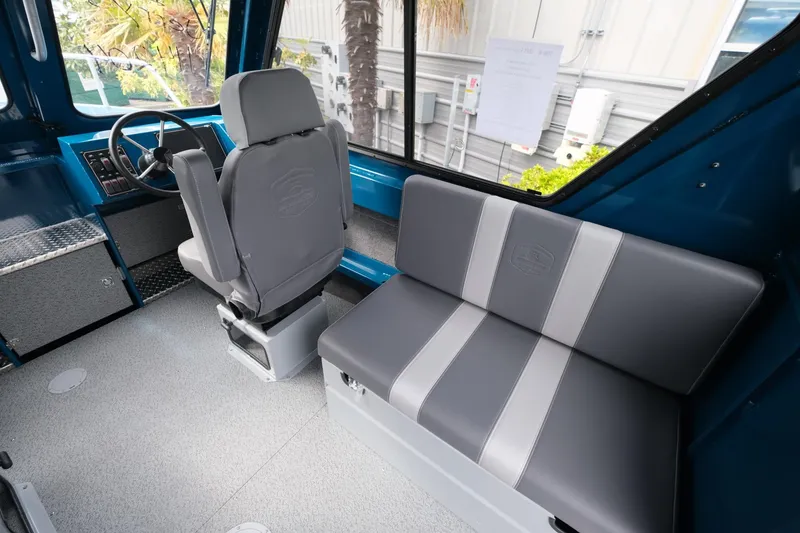 Slide: The Image of 2024 Hewescraft 220 Ocean Pro interior with gray seating and steering console. - 11
