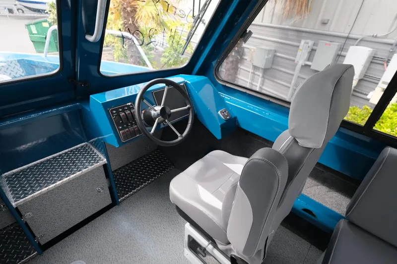 Slide: The Image of 2024 Hewescraft 220 Ocean Pro interior with steering wheel and seating. - 12