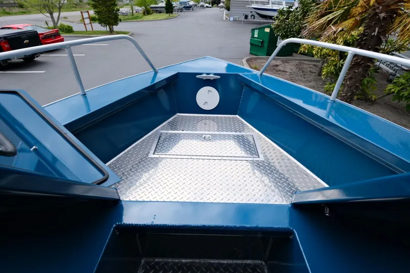 Slide: The Image of 2024 Hewescraft 220 Ocean Pro boat deck with diamond plate flooring. - 13