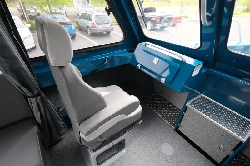 Slide: The Image of 2024 Hewescraft 220 Ocean Pro interior with captain's chair and storage compartments. - 14